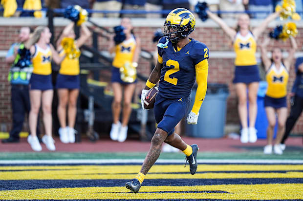 Michigan defensive back Will Johnson celebrates a touchdown after intercepting USC quarterback Miller Moss.