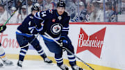 Apr 19, 2025; Winnipeg, Manitoba, CAN; Winnipeg Jets defenseman Dylan Samberg (54) looks to make a pass against St. Louis Blues during the first period in game one of the first round of the 2025 Stanley Cup Playoffs at Canada Life Centre. Mandatory Credit: Terrence Lee-Imagn Images