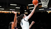 Iowa center Ava Heiden (5) lays the ball up as Ashland guard Lexi Howe (10) defends Oct. 30, 2025 during an exhibition game at Carver-Hawkeye Arena in Iowa City, Iowa.