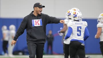 Kansas co-defensive coordinator and cornerbacks coach D.K. McDonald works with players during a team practice Tuesday, April 2, 2024, inside the Indoor Football Practice Facility.