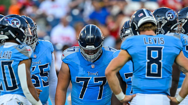 Aug 10, 2024; Nashville, Tennessee, USA;  Tennessee Titans offensive tackle Peter Skoronski (77) huddles up against the San Francisco 49ers during the first half at Nissan Stadium. Mandatory Credit: Steve Roberts-Imagn Images