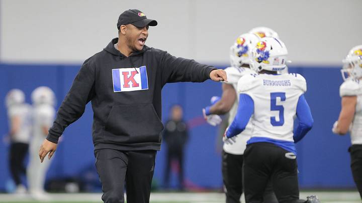 Kansas co-defensive coordinator and cornerbacks coach D.K. McDonald works with players during a team practice Tuesday, April 2, 2024, inside the Indoor Football Practice Facility.