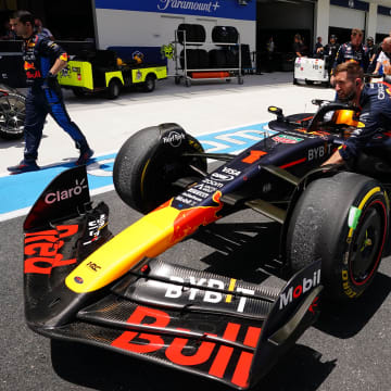 May 4, 2024; Miami Gardens, Florida, USA; Crew members push the car of Red Bull Racing driver Max Verstappen (1) back to the paddock  after the F1 Sprint Race at Miami International Autodrome. Mandatory Credit: John David Mercer-USA TODAY Sports