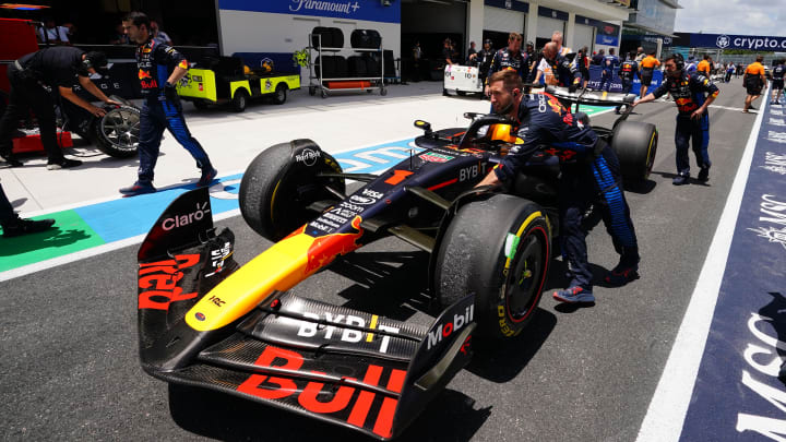 May 4, 2024; Miami Gardens, Florida, USA; Crew members push the car of Red Bull Racing driver Max Verstappen (1) back to the paddock  after the F1 Sprint Race at Miami International Autodrome. Mandatory Credit: John David Mercer-USA TODAY Sports