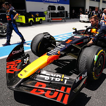 May 4, 2024; Miami Gardens, Florida, USA; Crew members push the car of Red Bull Racing driver Max Verstappen (1) back to the paddock  after the F1 Sprint Race at Miami International Autodrome. Mandatory Credit: John David Mercer-Imagn Images