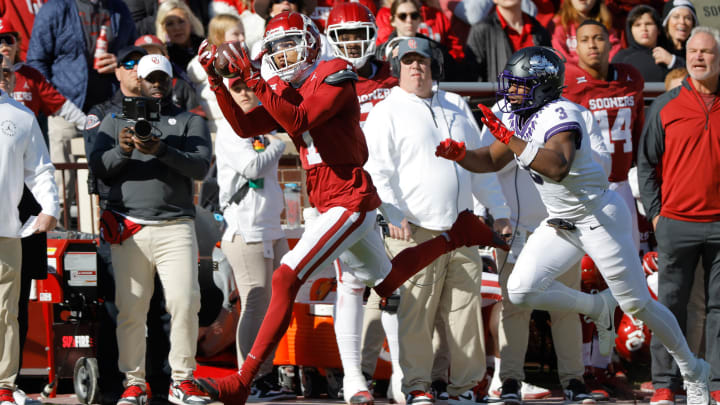 Nov 24, 2023; Norman, Oklahoma, USA; Oklahoma Sooners wide receiver Jayden Gibson (1) catchers a pass for a touchdown against TCU Horned Frogs safety Mark Perry (3) at Gaylord Family-Oklahoma Memorial Stadium. Mandatory Credit: Bryan Terry-USA TODAY Sports