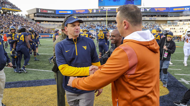 Nov 20, 2021; Morgantown, West Virginia, USA; West Virginia Mountaineers head coach Neal Brown talks with Texas Longhorns head coach Steve Sarkisian after the game at Mountaineer Field at Milan Puskar Stadium. Mandatory Credit: Ben Queen-Imagn Images Nov 20, 2021; Morgantown, West Virginia, USA; West Virginia Mountaineers head coach Neal Brown talks with Texas Longhorns head coach Steve Sarkisian after the game at Mountaineer Field at Milan Puskar Stadium. Mandatory Credit: Ben Queen-Imagn Images