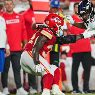 Sep 5, 2024; Kansas City, Missouri, USA; Baltimore Ravens tight end Isaiah Likely (80) runs with the ball against Kansas City Chiefs linebacker Nick Bolton (32) during the second half at GEHA Field at Arrowhead Stadium. Mandatory Credit: Jay Biggerstaff-Imagn Images