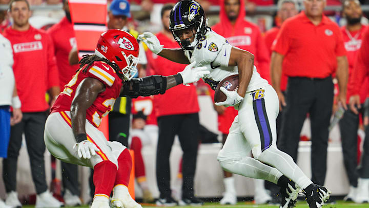 Sep 5, 2024; Kansas City, Missouri, USA; Baltimore Ravens tight end Isaiah Likely (80) runs with the ball against Kansas City Chiefs linebacker Nick Bolton (32) during the second half at GEHA Field at Arrowhead Stadium. Mandatory Credit: Jay Biggerstaff-Imagn Images