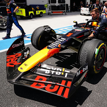 May 4, 2024; Miami Gardens, Florida, USA; Crew members push the car of Red Bull Racing driver Max Verstappen (1) back to the paddock  after the F1 Sprint Race at Miami International Autodrome. Mandatory Credit: John David Mercer-Imagn Images