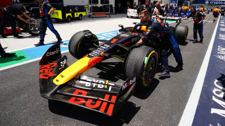 May 4, 2024; Miami Gardens, Florida, USA; Crew members push the car of Red Bull Racing driver Max Verstappen (1) back to the paddock  after the F1 Sprint Race at Miami International Autodrome. Mandatory Credit: John David Mercer-USA TODAY Sports