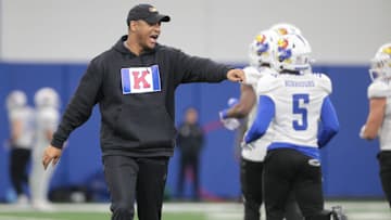 Kansas co-defensive coordinator and cornerbacks coach D.K. McDonald works with players during a team practice Tuesday, April 2, 2024, inside the Indoor Football Practice Facility.