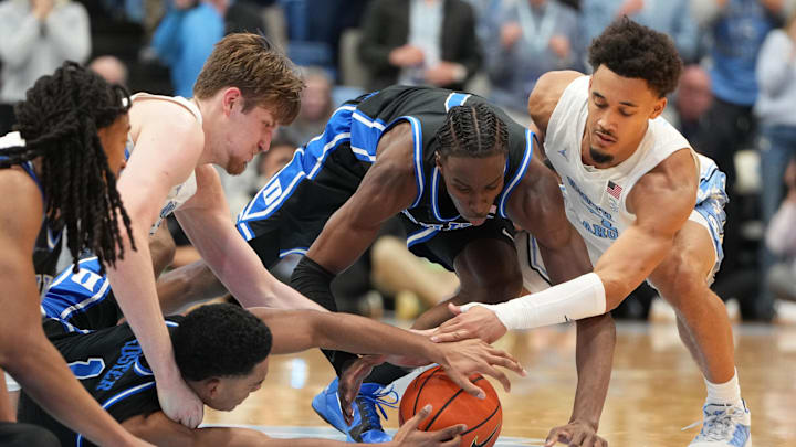 Feb 7, 2026; Chapel Hill, North Carolina, USA; Duke Blue Devils forward Maliq Brown (6) and guards Caleb Foster (1) and Dame Sarr (7) and North Carolina Tar Heels center Henri Veesaar (13) and guard Seth Trimble (7) fight for the ball in the second half at Dean E. Smith Center. Mandatory Credit: Bob Donnan-Imagn Images