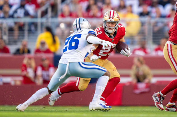 San Francisco 49ers running back Christian McCaffrey runs the football against Dallas Cowboys cornerback DaRon Bland