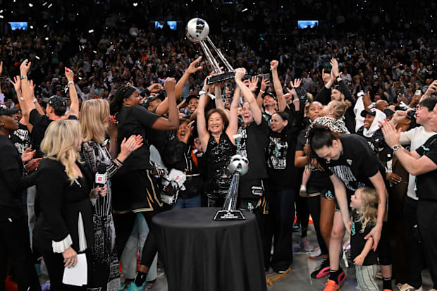 The New York Liberty hold up the WNBA championship trophy after winning the 2024 title. 