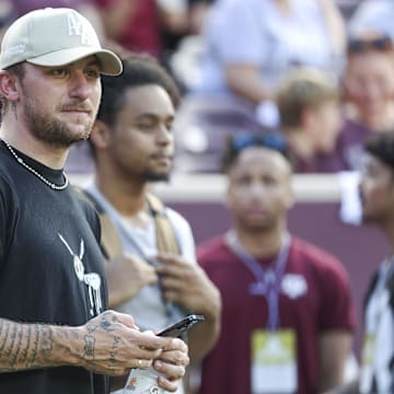 Sep 16, 2023; College Station, Texas, USA; Former Texas A&M Aggies player Johnny Manziel watches from the sideline during the first half of the game between the Aggies and the Louisiana Monroe Warhawks at Kyle Field. Mandatory Credit: Troy Taormina-Imagn Images