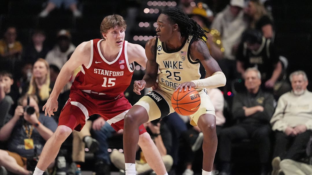 Feb 14, 2026; Winston-Salem, North Carolina, USA;  Wake Forest Demon Deacons forward Tre'von Spillers (25) handles the ball defended by Stanford Cardinal forward Oskar Giltay (15) during the second half at Lawrence Joel Veterans Memorial Coliseum. Mandatory Credit: Jim Dedmon-Imagn Images