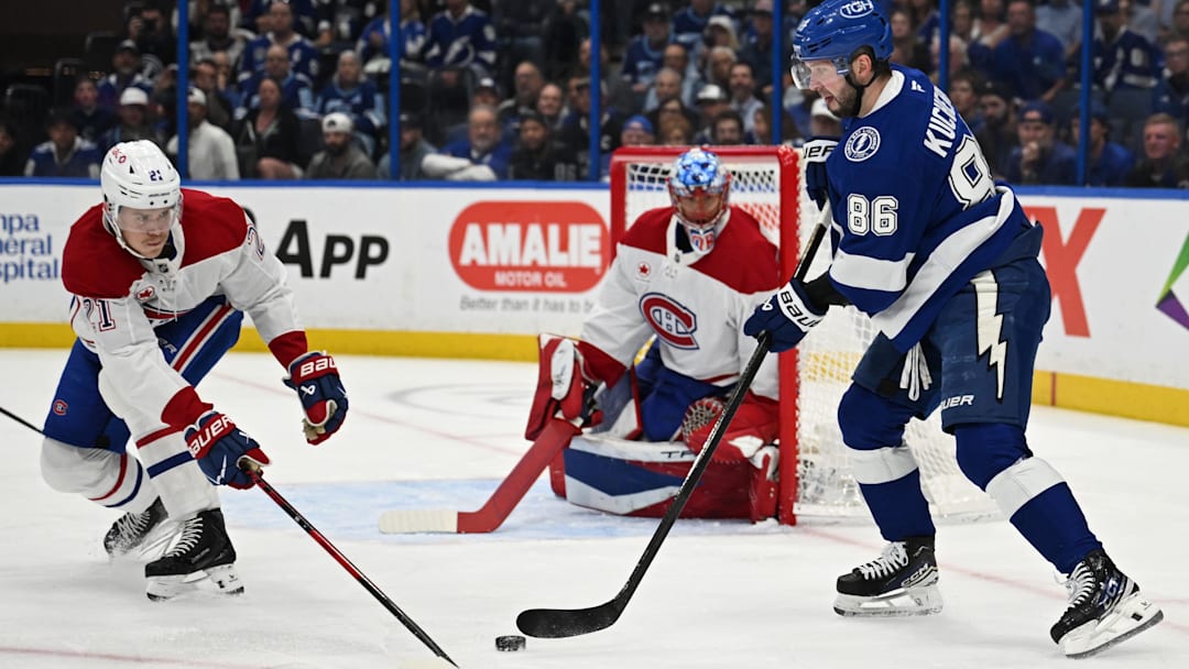 Mar 31, 2026; Tampa, Florida, USA; Tampa Bay Lightning right wing Nikita Kucherov (86) attempts to get past Montreal Canadian defensemen Kaiden Guhle (21) in the first period at Benchmark International Arena. Mandatory Credit: Jonathan Dyer-Imagn Images