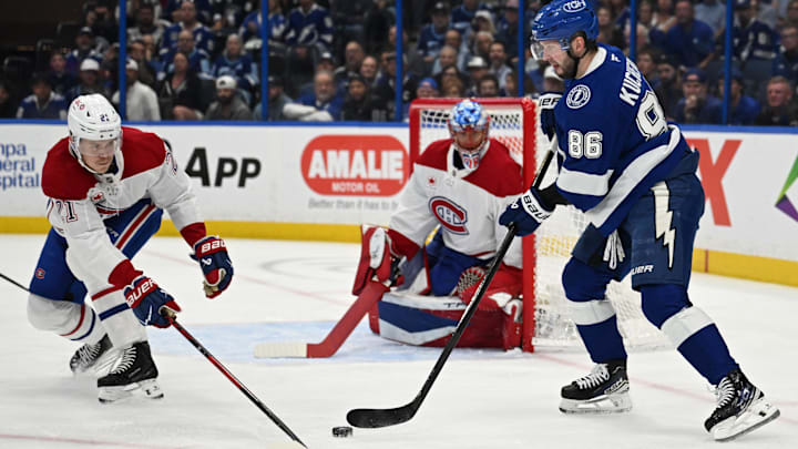 Mar 31, 2026; Tampa, Florida, USA; Tampa Bay Lightning right wing Nikita Kucherov (86) attempts to get past Montreal Canadian defensemen Kaiden Guhle (21) in the first period at Benchmark International Arena. Mandatory Credit: Jonathan Dyer-Imagn Images