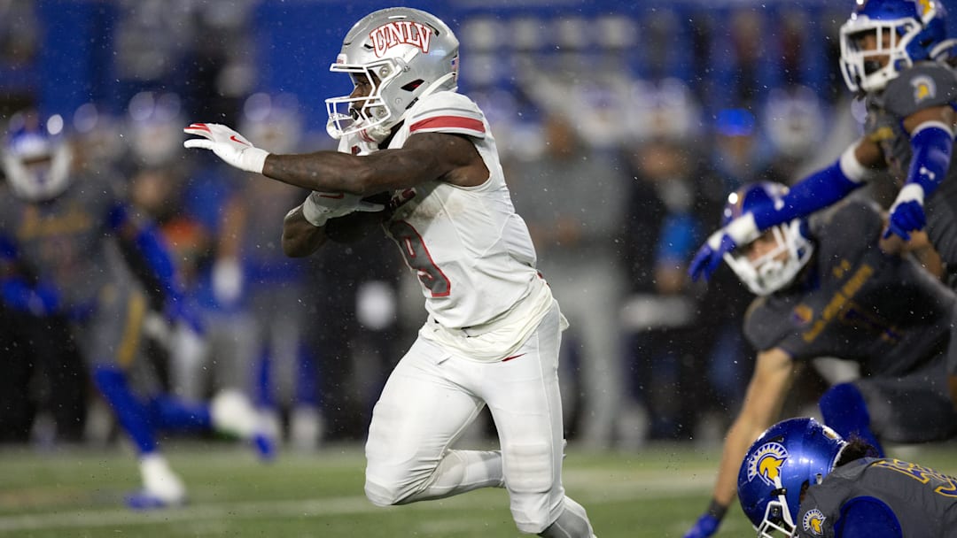 Nov 22, 2024; San Jose, California; UNLV Rebels running back Jai'Den Thomas (9) looks for running room against the San Jose State Spartans during the second quarter at CEFCU Stadium. 