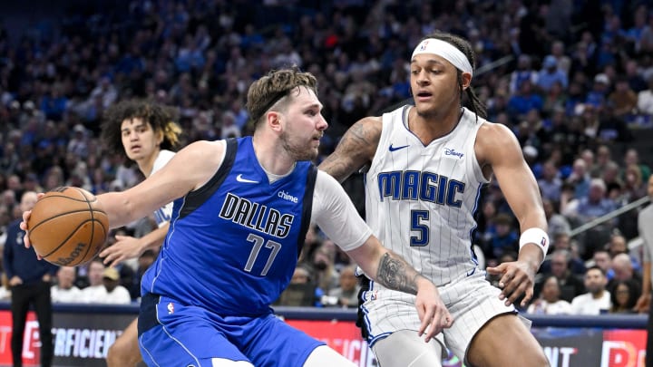 Jan 29, 2024; Dallas, Texas, USA; Dallas Mavericks guard Luka Doncic (77) and Orlando Magic forward Paolo Banchero (5) in action during the game between the Dallas Mavericks and the Orlando Magic at the American Airlines Center. Mandatory Credit: Jerome Miron-USA TODAY Sports