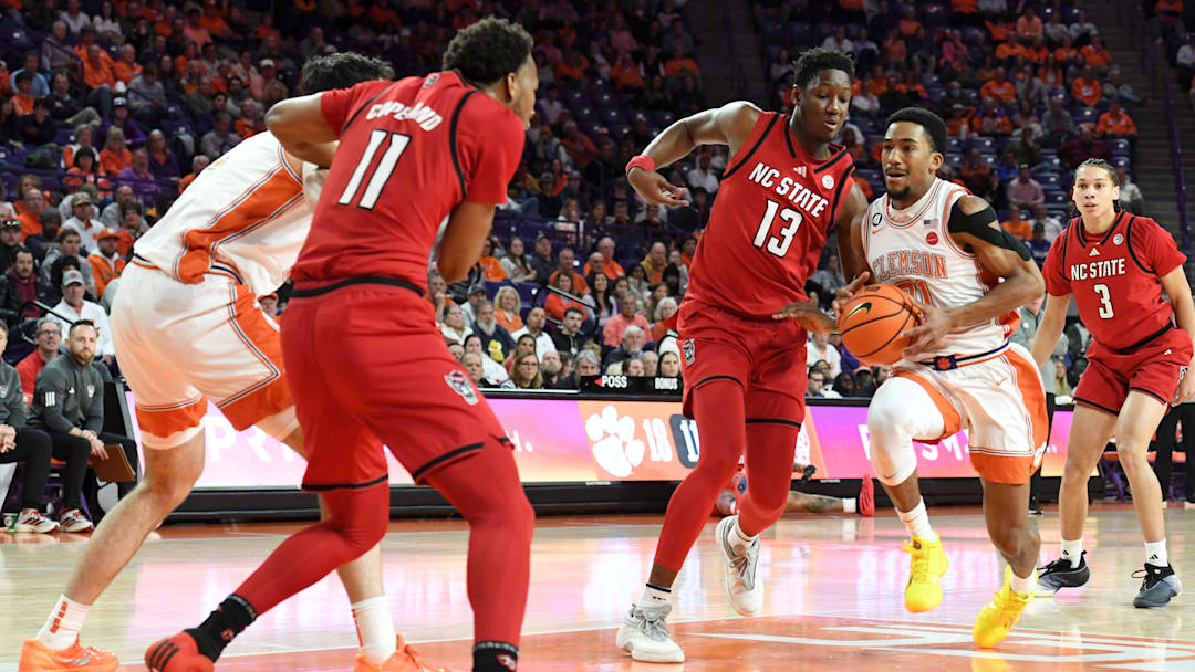 Clemson guard Ace Buckner (21) is defended by NC State forward Musa Sagnia (13) on Tuesday, Jan. 20, 2026..