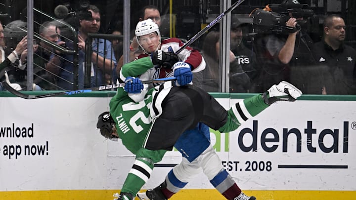 Mar 6, 2026; Dallas, Texas, USA; Dallas Stars center Roope Hintz (24) appears to suffer a lower body injury as he is engages with Colorado Avalanche center Nathan MacKinnon (29) along the boards during the second period at the American Airlines Center. Mandatory Credit: Jerome Miron-Imagn Images
