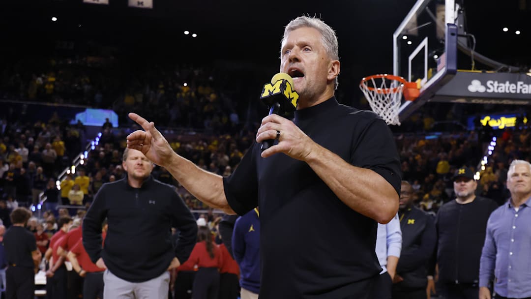 Jan 2, 2026; Ann Arbor, Michigan, USA;  Michigan Wolverines football head coach Kyle Whittingham speaks to the crowd during a time out in the first half against the Southern California Trojans at Crisler Center. Mandatory Credit: Rick Osentoski-Imagn Images