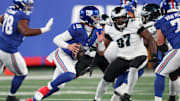 Oct 9, 2025; East Rutherford, New Jersey, USA; New York Giants quarterback Jaxson Dart (6) scrambles with the ball against the Philadelphia Eagles during the first quarter of the game at MetLife Stadium. Mandatory Credit: Vincent Carchietta-Imagn Images