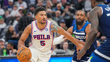 Mar 4, 2025; Minneapolis, Minnesota, USA; Philadelphia 76ers guard Quentin Grimes (5) dribbles against the Minnesota Timberwolves guard Mike Conley (10) in the third quarter at Target Center. Mandatory Credit: Brad Rempel-Imagn Images
