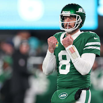 Jan 5, 2025; East Rutherford, New Jersey, USA; New York Jets quarterback Aaron Rodgers (8) gestures towards the Miami Dolphins bench during the second half at MetLife Stadium. Mandatory Credit: Vincent Carchietta-Imagn Images