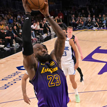 Los Angeles Lakers forward LeBron James (23) goes up for a dunk past Orlando Magic guard Jalen Suggs (4) in the second half at Crypto.com Arena.