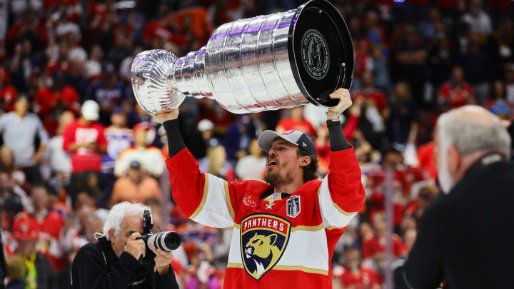 Jun 24, 2024; Sunrise, Florida, USA; Florida Panthers center Nick Cousins (21) lifts the cup after winning game seven of the 2024 Stanley Cup Final against the Edmonton Oilers at Amerant Bank Arena. Mandatory Credit: Sam Navarro-USA TODAY Sports