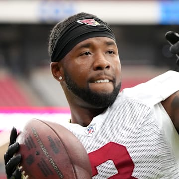 Arizona Cardinals safety Budda Baker (3) plays catch with fans during training camp at State Farm Stadium in Glendale on July 28, 2024.