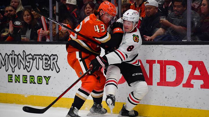 Mar 1, 2025; Anaheim, California, USA; Anaheim Ducks defenseman Drew Helleson (43) hits Chicago Blackhawks center Ryan Donato (8) while playing for the puck during the first period at Honda Center. Mandatory Credit: Gary A. Vasquez-Imagn Images