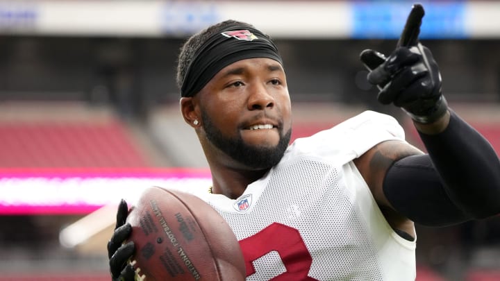 Arizona Cardinals safety Budda Baker (3) plays catch with fans during training camp at State Farm Stadium in Glendale on July 28, 2024.