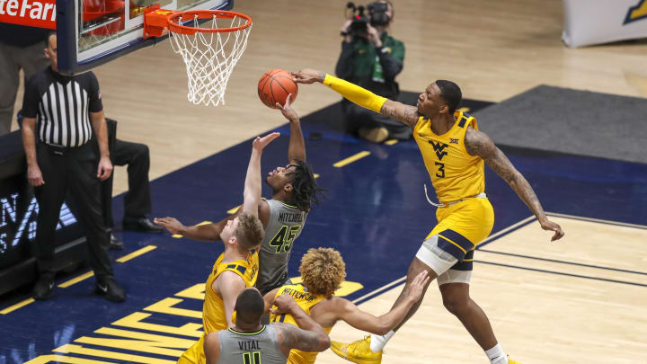 Mar 2, 2021; Morgantown, West Virginia, USA; West Virginia Mountaineers forward Gabe Osabuohien (3) blocks a shot from Baylor Bears guard Davion Mitchell (45) during the second half at WVU Coliseum. 