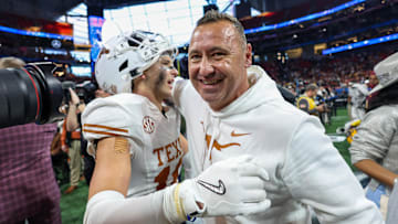 Jan 1, 2025; Atlanta, GA, USA; Texas Longhorns defensive back Michael Taaffe (16) and head coach Steve Sarkisian celebrate after a victory over the Arizona State Sun Devils in the Peach Bowl at Mercedes-Benz Stadium.