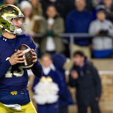 Nov 8, 2025; South Bend, Indiana, USA; Notre Dame Fighting Irish quarterback CJ Carr (13) looks to pass against the Navy Midshipmen during the first half at Notre Dame Stadium. 