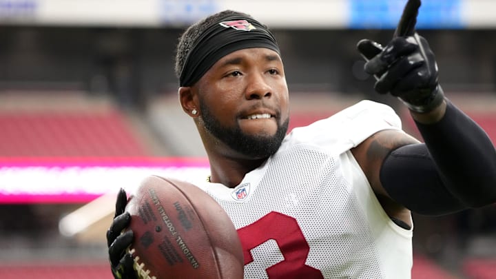 Arizona Cardinals safety Budda Baker (3) plays catch with fans during training camp at State Farm Stadium in Glendale on July 28, 2024.