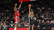 Dec 3, 2025; Atlanta, Georgia, USA; Atlanta Hawks guard Dyson Daniels (5) shoots over LA Clippers guard James Harden (1) during the first half at State Farm Arena. Mandatory Credit: Dale Zanine-Imagn Images