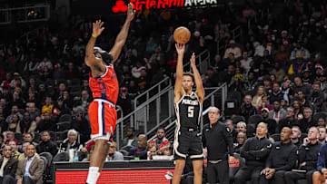 Dec 3, 2025; Atlanta, Georgia, USA; Atlanta Hawks guard Dyson Daniels (5) shoots over LA Clippers guard James Harden (1) during the first half at State Farm Arena. Mandatory Credit: Dale Zanine-Imagn Images