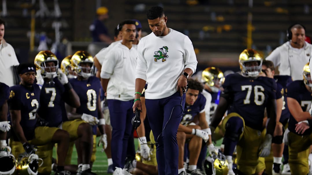 Sep 13, 2025; South Bend, Indiana, USA; Notre Dame Fighting Irish head coach Marcus Freeman looks on as the team takes a knee for Notre Dame Fighting Irish tight end Eli Raridon (9) after an apparent injury against Texas A&M Aggies during the second half at Notre Dame Stadium. Mandatory Credit: Trevor Ruszkowski-Imagn Images