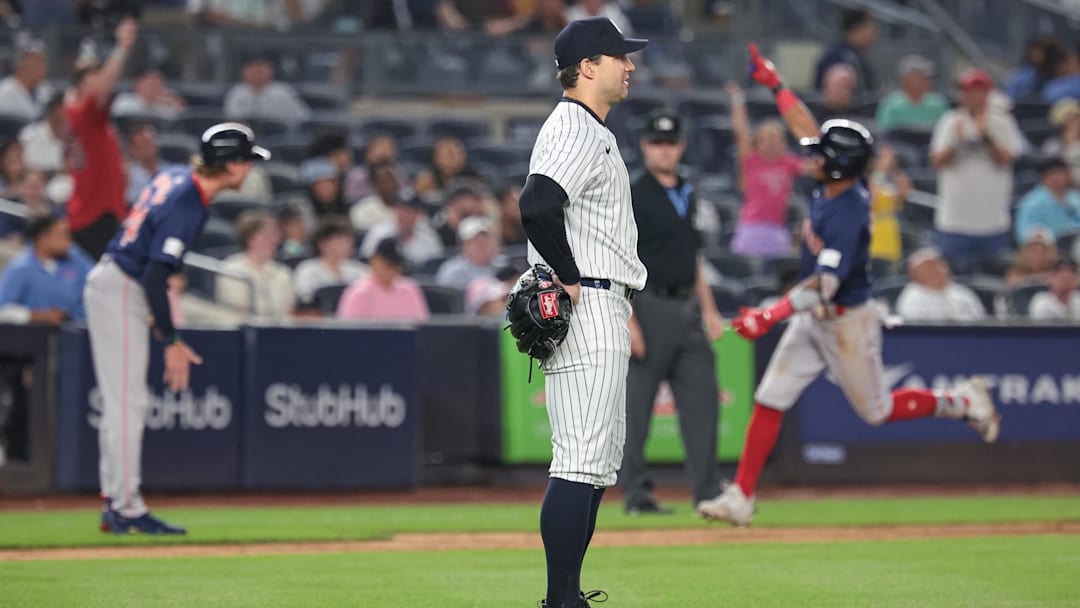 Jul 5, 2024; Bronx, New York, USA; New York Yankees relief pitcher Tommy Kahnle (41) looks up as Boston Red Sox center fielder Ceddanne Rafaela (43) celebrates his two run home run while running the bases during the tenth inning at Yankee Stadium. Mandatory Credit: Vincent Carchietta-Imagn Images