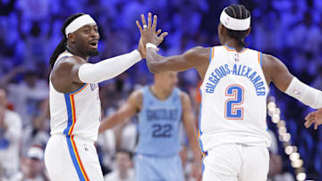 Apr 20, 2025; Oklahoma City, Oklahoma, USA; Oklahoma City Thunder guard Luguentz Dort (5) high fives guard Shai Gilgeous-Alexander (2) after scoring a three point basket against the Memphis Grizzlies during the second half at Paycom Center. Mandatory Credit: Alonzo Adams-Imagn Images