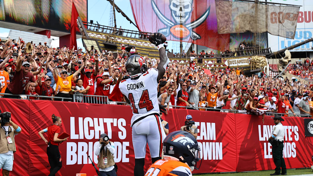 Sep 22, 2024; Tampa, Florida, USA; Tampa Bay Buccaneers wide receiver Chris Godwin (14) celebrates after he scored a touchdown against the Denver Broncos during the first half at Raymond James Stadium. Mandatory Credit: Kim Klement Neitzel-Imagn Images