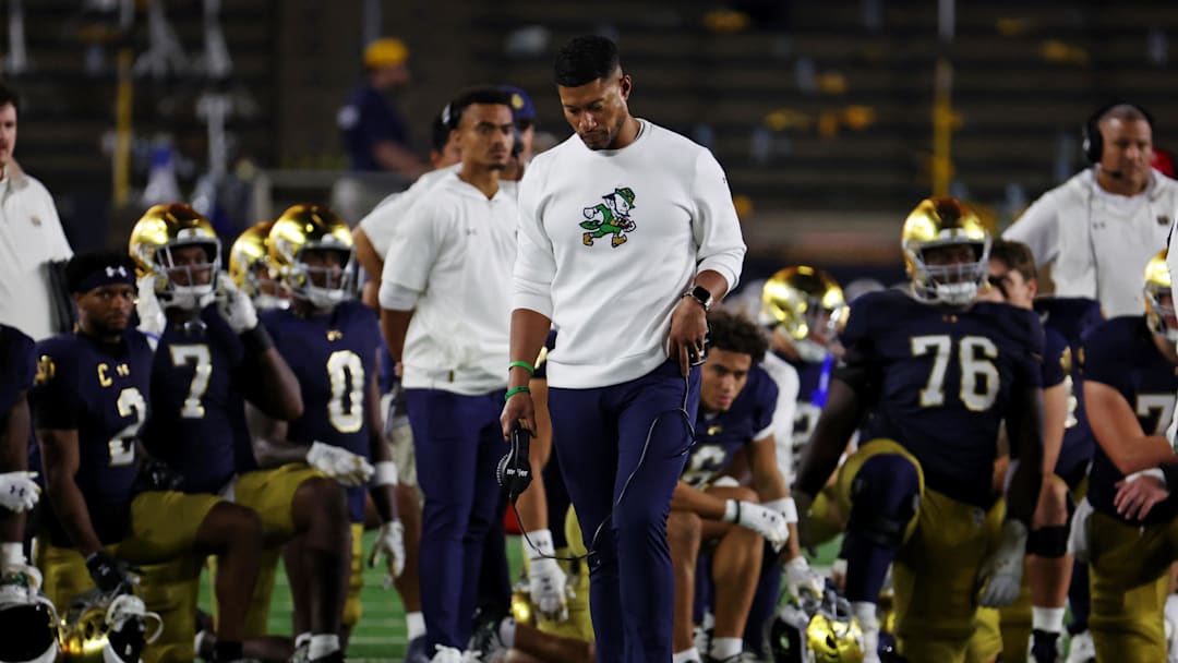Sep 13, 2025; South Bend, Indiana, USA; Notre Dame Fighting Irish head coach Marcus Freeman looks on as the team takes a knee for Notre Dame Fighting Irish tight end Eli Raridon (9) after an apparent injury against Texas A&M Aggies during the second half at Notre Dame Stadium. Mandatory Credit: Trevor Ruszkowski-Imagn Images Sep 13, 2025; South Bend, Indiana, USA; Notre Dame Fighting Irish head coach Marcus Freeman looks on as the team takes a knee for Notre Dame Fighting Irish tight end Eli Raridon (9) after an apparent injury against Texas A&M Aggies during the second half at Notre Dame Stadium. Mandatory Credit: Trevor Ruszkowski-Imagn Images