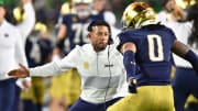 Oct 14, 2023; South Bend, Indiana, USA; Notre Dame Fighting Irish head coach Marcus Freeman celebrates with safety Xavier Watts (0) after Watts intercepted a pass in the first quarter against the USC Trojans at Notre Dame Stadium. Notre Dame won 48-20. 