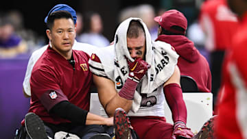 Dec 7, 2025; Minneapolis, Minnesota, USA; Washington Commanders tight end Zach Ertz (86) is carted off the field after an injury during the second half at U.S. Bank Stadium. 