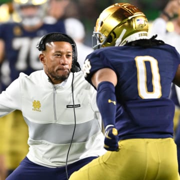 Oct 14, 2023; South Bend, Indiana, USA; Notre Dame Fighting Irish head coach Marcus Freeman celebrates with safety Xavier Watts (0) after Watts intercepted a pass in the first quarter against the USC Trojans at Notre Dame Stadium. Notre Dame won 48-20. Mandatory Credit: Matt Cashore-USA TODAY Sports